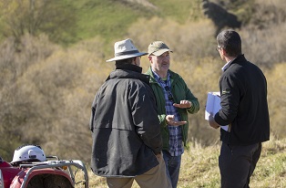 image of three farmers discussing on farm