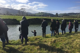 image of farmers looking at river