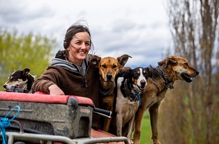 image of female cadet on quad with dogs