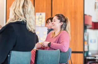 image of three women siting in conference