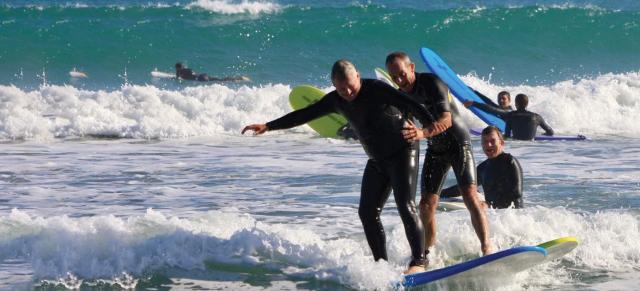 image of two farmers surfing the waves