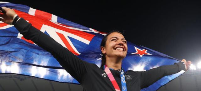 image of Stacey Waaka carrying NZ flag