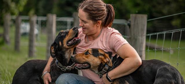 image of Olivia Weatherburn and two farm dogs