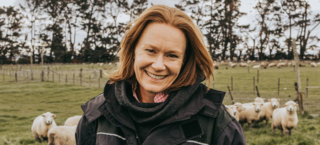 image of Ginny Dodunski on farm with sheep