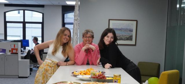 image of Zowie Ransfield, Dionne and Holly around B+LNZ Wellington office kitchen