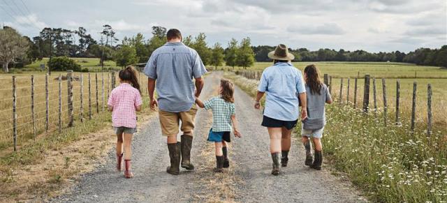 image of Maori family holding hands on farm road