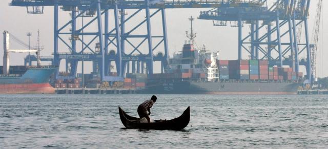 image of boat infront of trade port in India