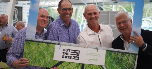 image of B+LNZ staff at Out the Gate conference standing behind sign