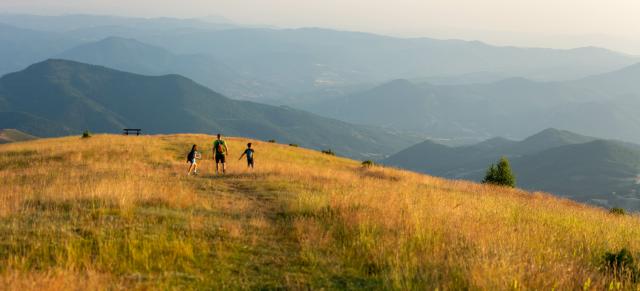 image of family on dry farm overlooking moutains