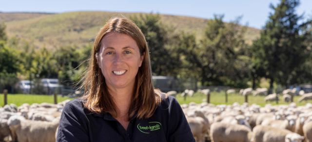 image of Kate Acland on farm infront of sheep
