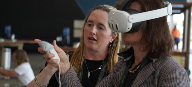 image of Olivia Weatherburn and attendee testing AV equipment