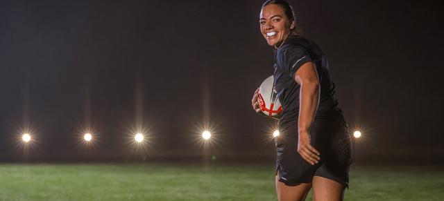 image of Stacey Waka looking back with a rugby ball