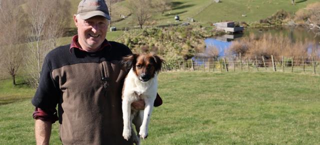 image of Steve with his dog infront of the river