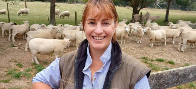 image of mary bowron infront of sheep pen
