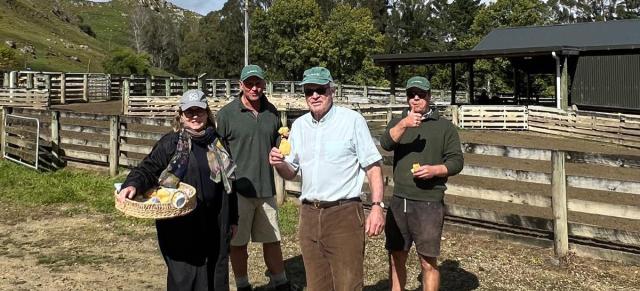 image of councillors at farm carrying basket 