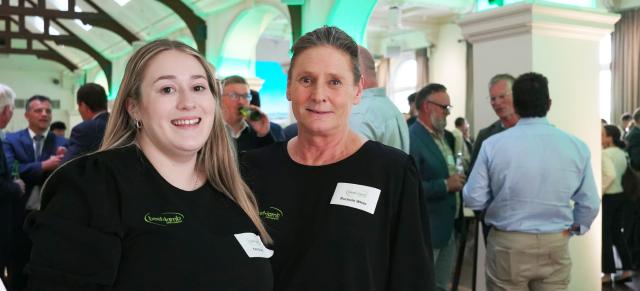 image of two female staff in B+LNZ branded gear at event