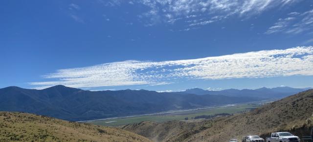 image of farm with utes driving up road