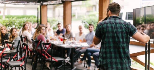 image of presenter talking at dinner