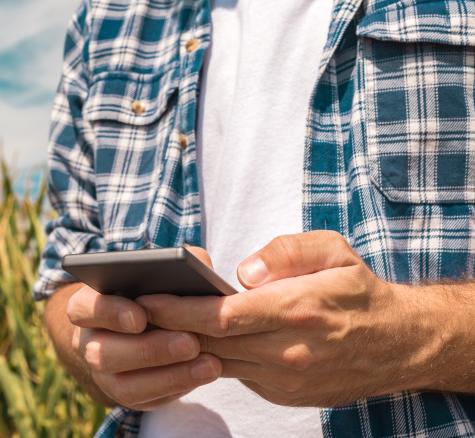 image of farmer using cellphone
