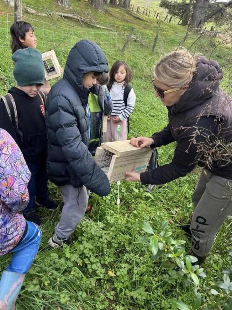 image of catchment members and children setting up traps