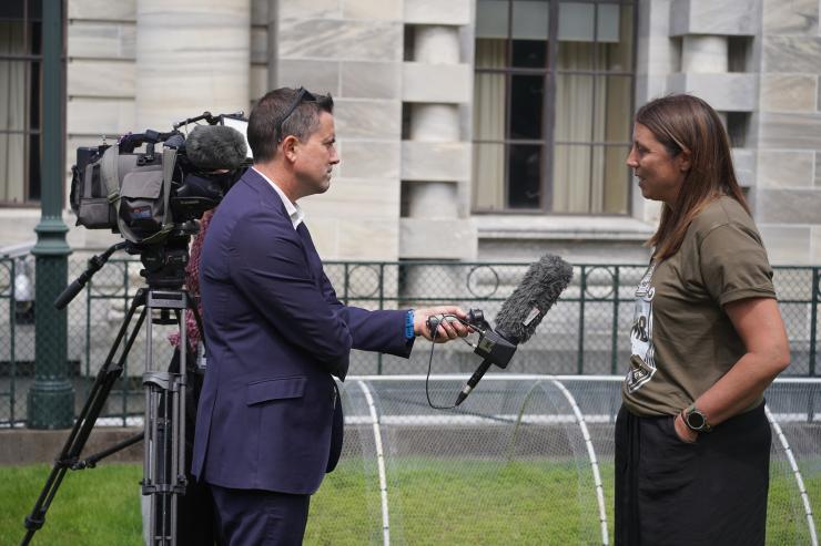 image of Kate Acland talking to press