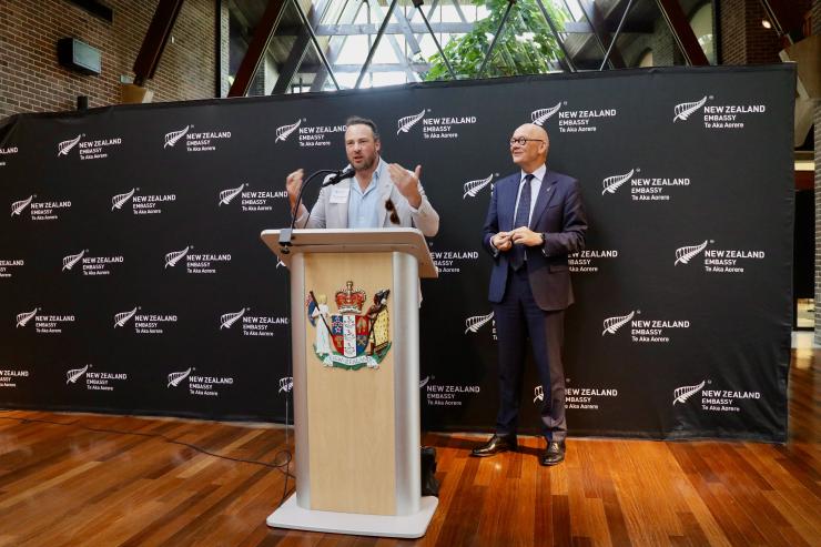 Image of two delegates speaking at podium