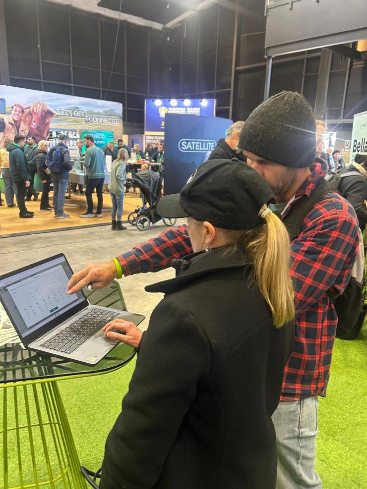 image of two people looking at laptop at fieldays
