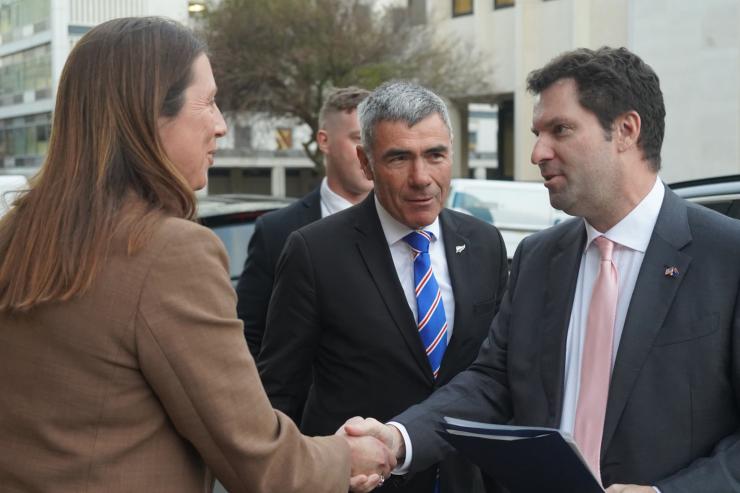 Kate Acland shaking the US Ambassador's hand