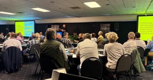 image taken from Genetics Forum of audience watching presentation