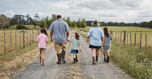 image of Maori family holding hands on farm road