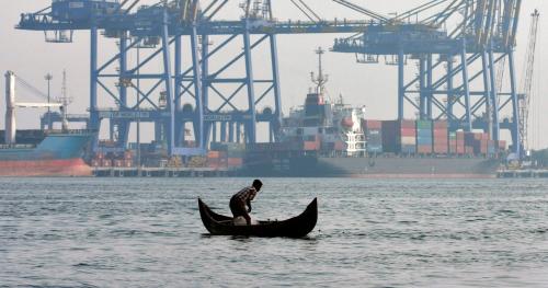 image of boat infront of trade port in India