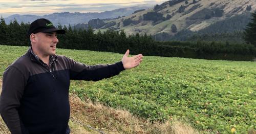 image of Tom Orchinston pointing at mountains