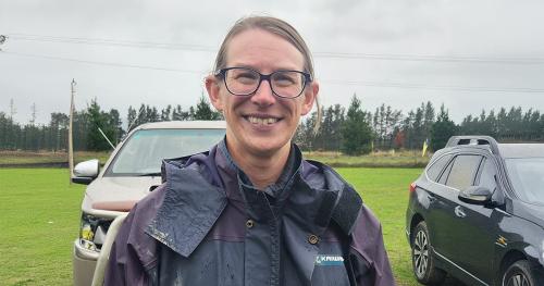 image of female farmer infront of two vehicles