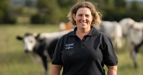 image of Sonya Shaw infront of dairy cows