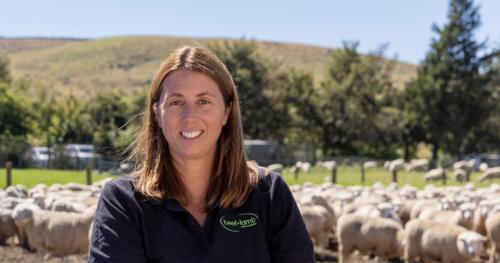image of Kate Acland on farm infront of sheep