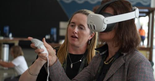 image of Olivia Weatherburn and attendee testing AV equipment