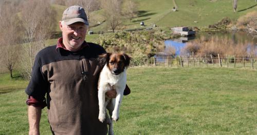 image of Steve with his dog infront of the river