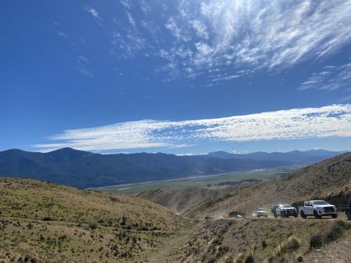 image of farm with utes driving up road