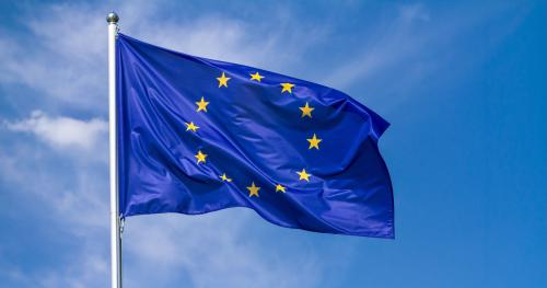 European Union flag blowing in wind with blue sky