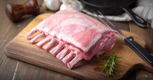 image of fresh lamb rack on cutting board next to knife