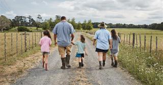 image of Maori family holding hands on farm road