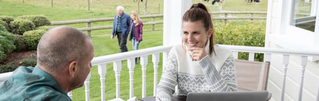 image of female and male talking on balcony
