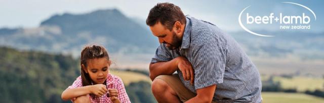 image of father and daughter picking grass on farm