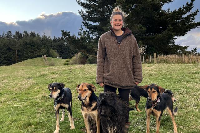 image of Lana Chrystal on farm with three dogs