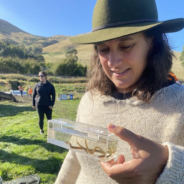image of Sarah Mukai looking at sample in tube
