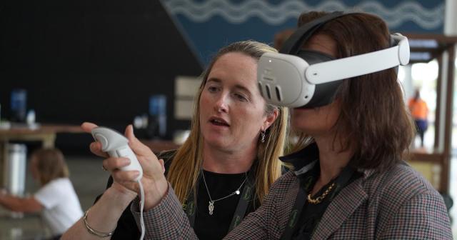 image of two women demonstrating virtual reality
