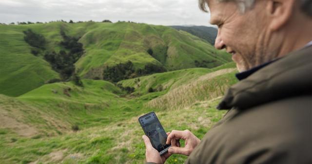 image of man using cellphone for virtual fencing