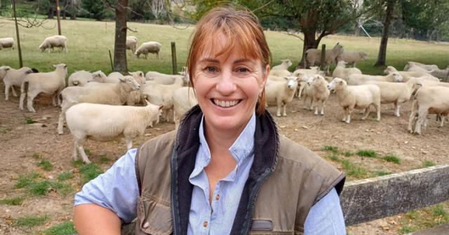 image of mary bowron infront of sheep pen