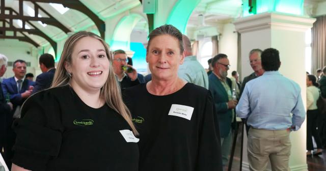 image of two female staff in B+LNZ branded gear at event