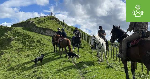 Image of farmers on horse going up a hill